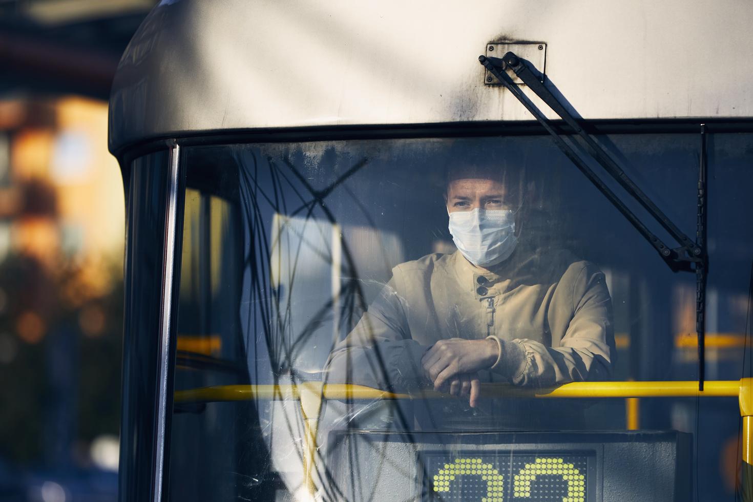 man wearing a mask in public transport