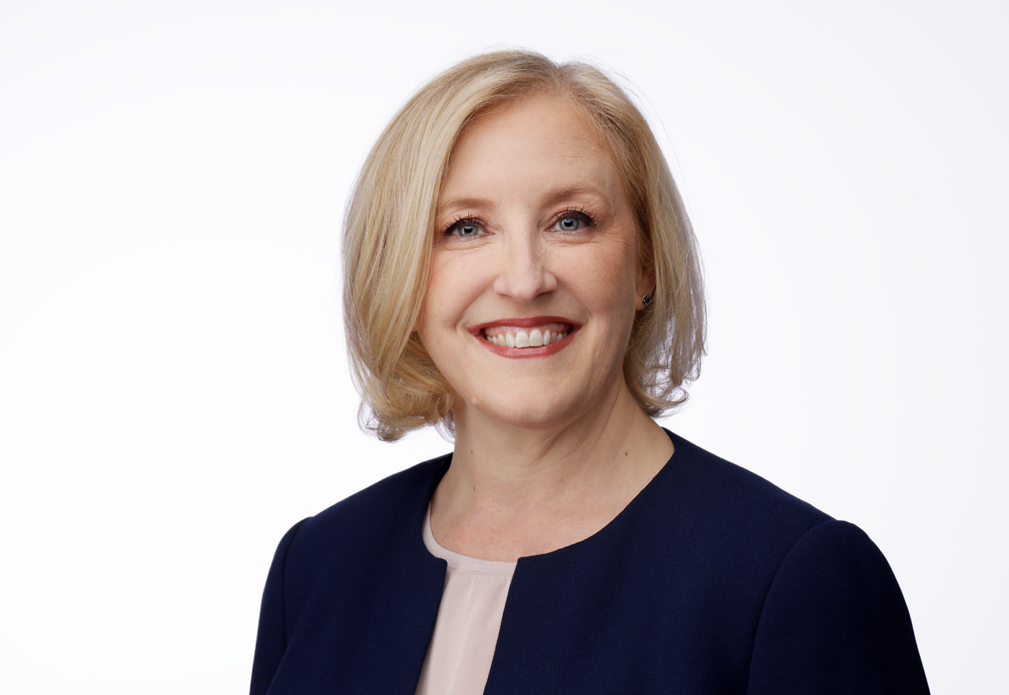 Lisa Raitt smiling with a blank background