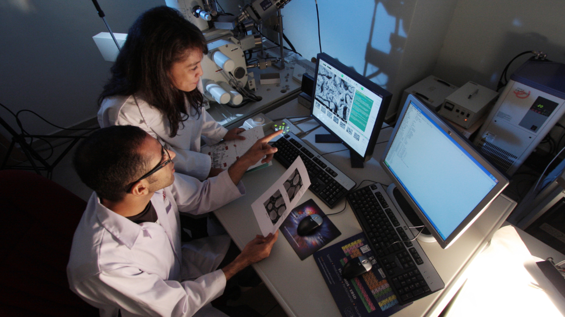Two researchers looking at computers.