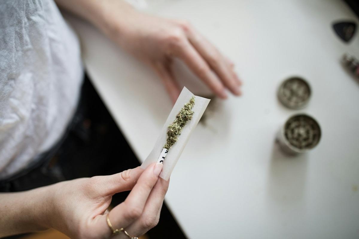 Woman rolling a marijuana cigarette