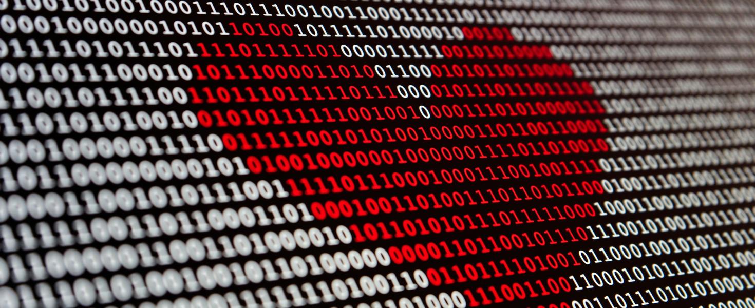Binary digits on a screen with a heart shape highlighted in red