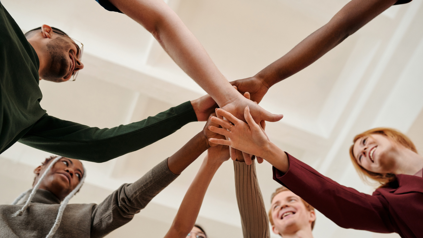 People putting their hands together.