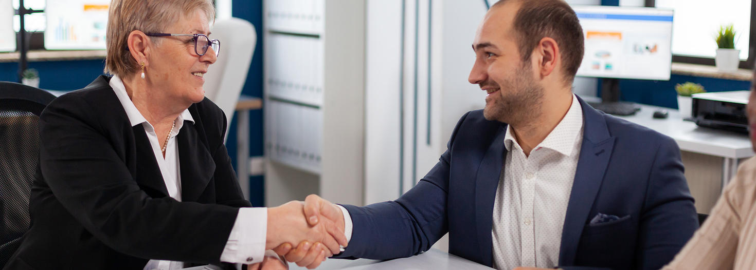 Consultant shaking hands with a client.