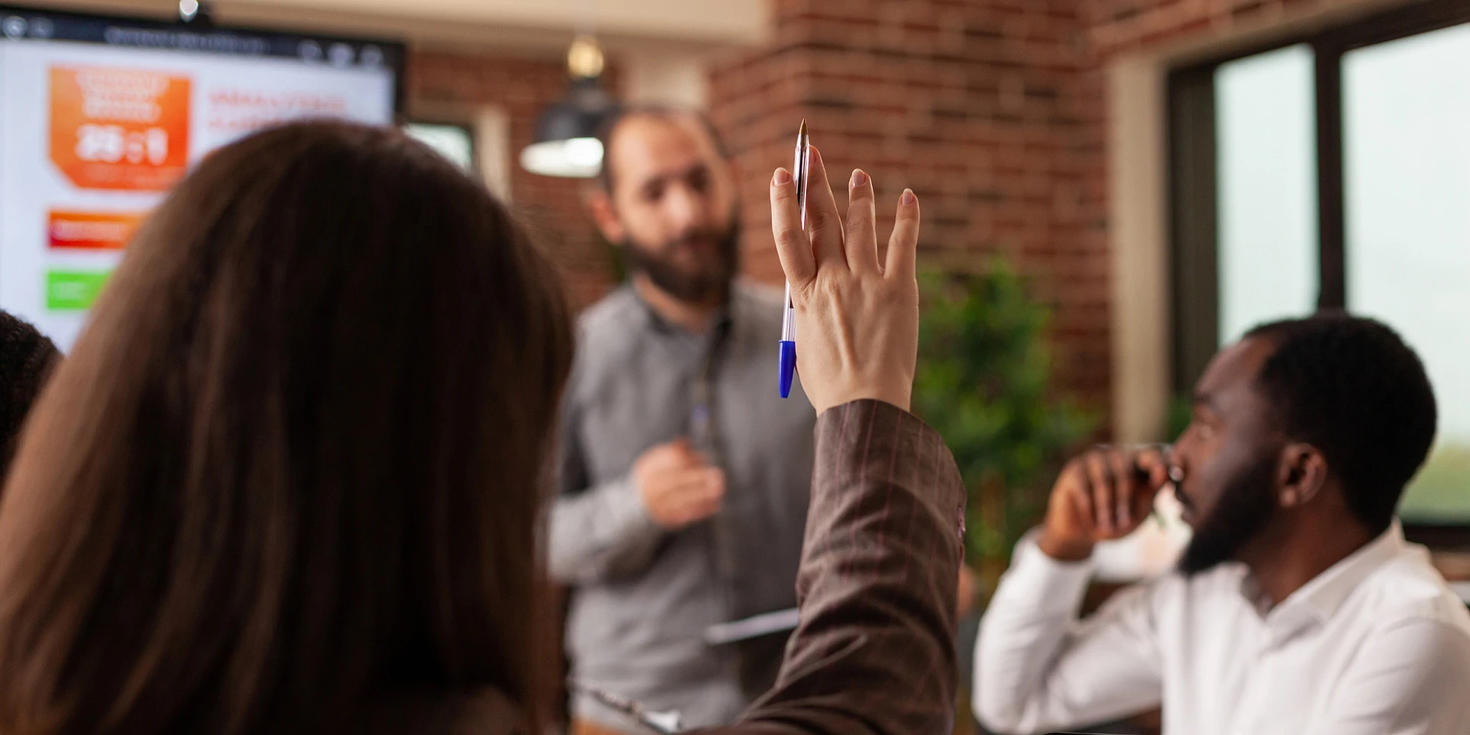 Woman raising her hand during a workshop