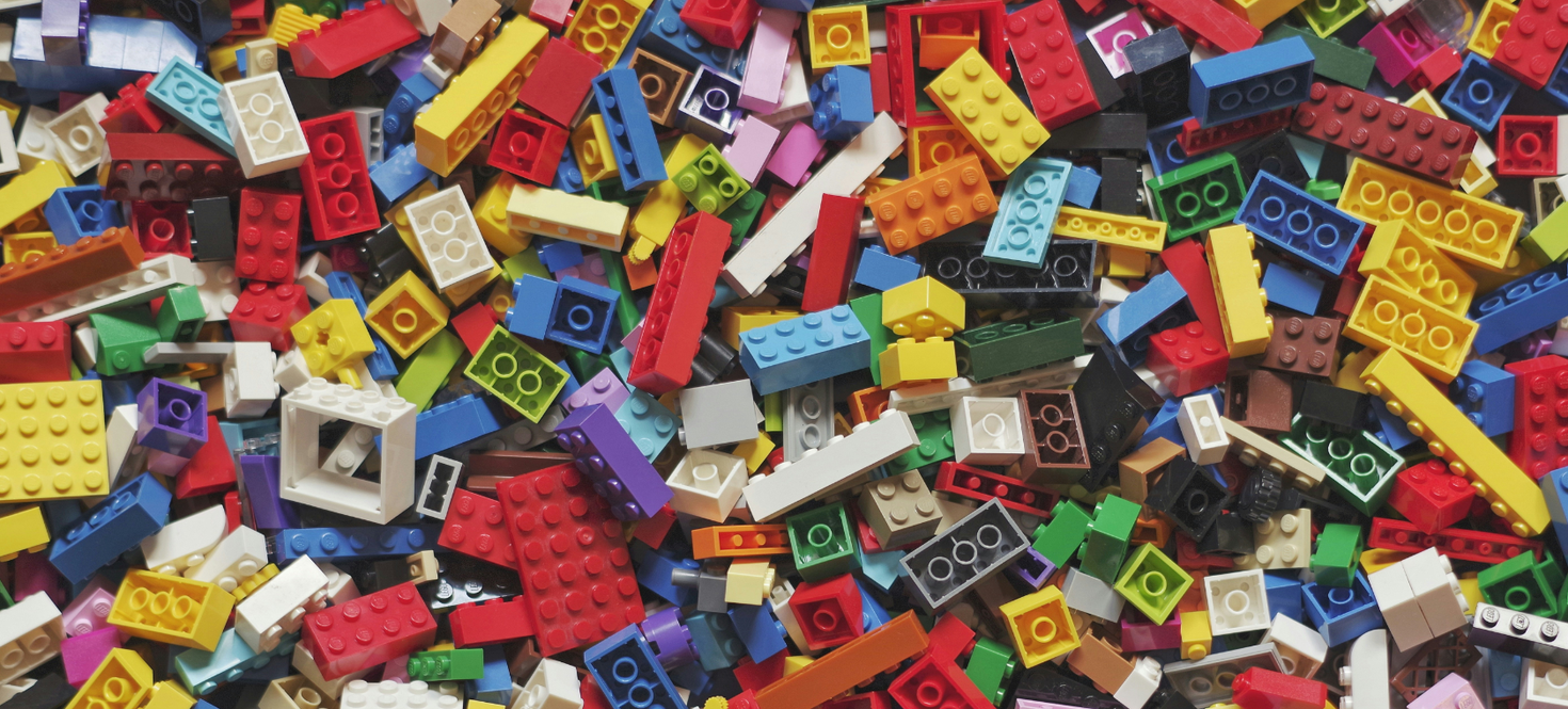 Many LEGO bricks displayed on a plane surface