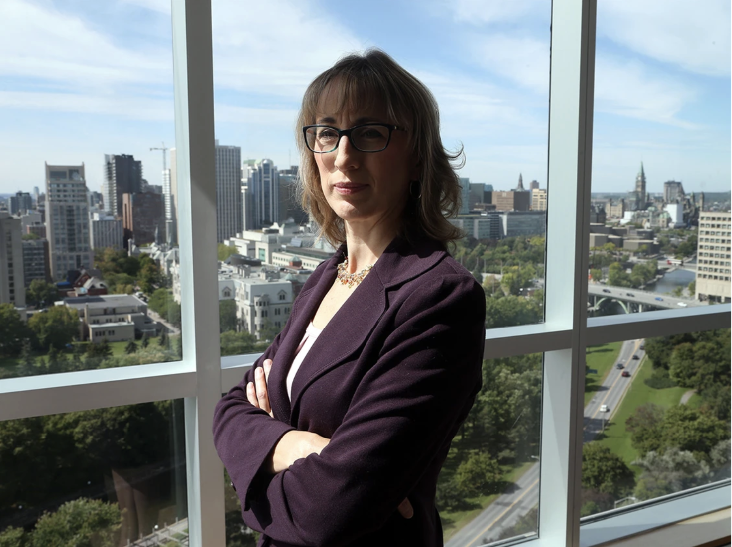 Monica Gattinger standing in front of a panoramic window
