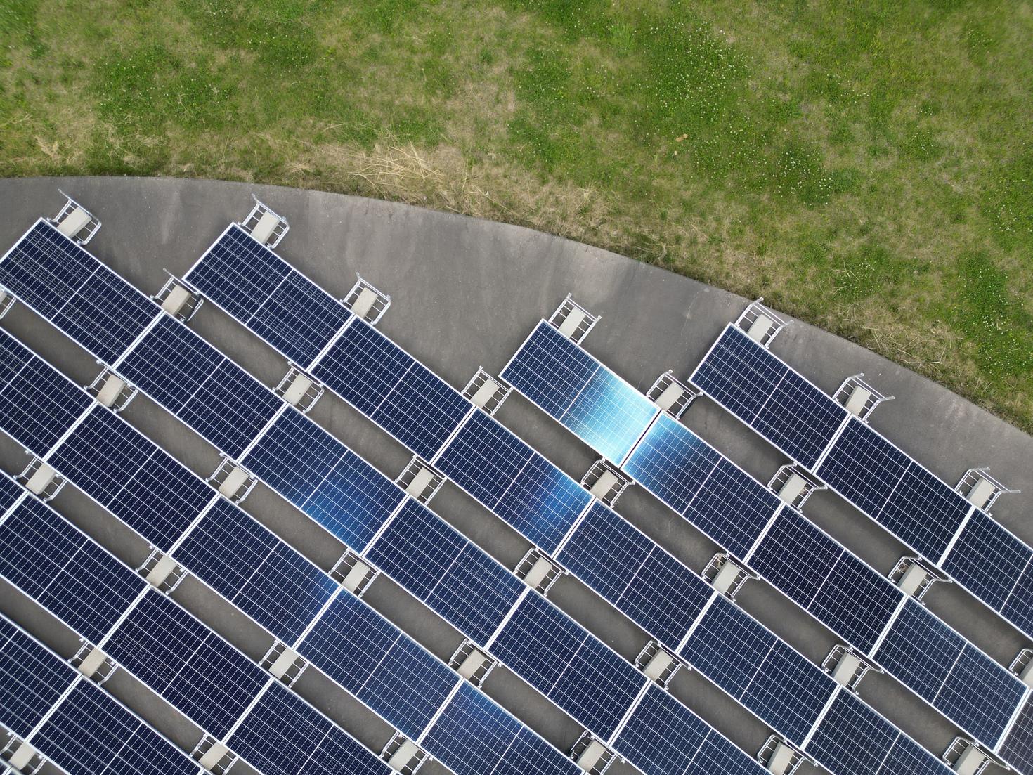 An overhead view of solar panels in a field.