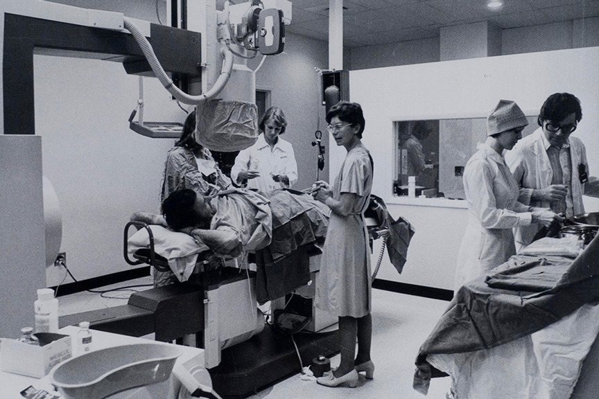 A group of people in an operating room.