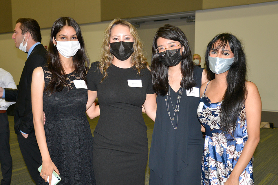 Three medical learners pose wearing face masks.