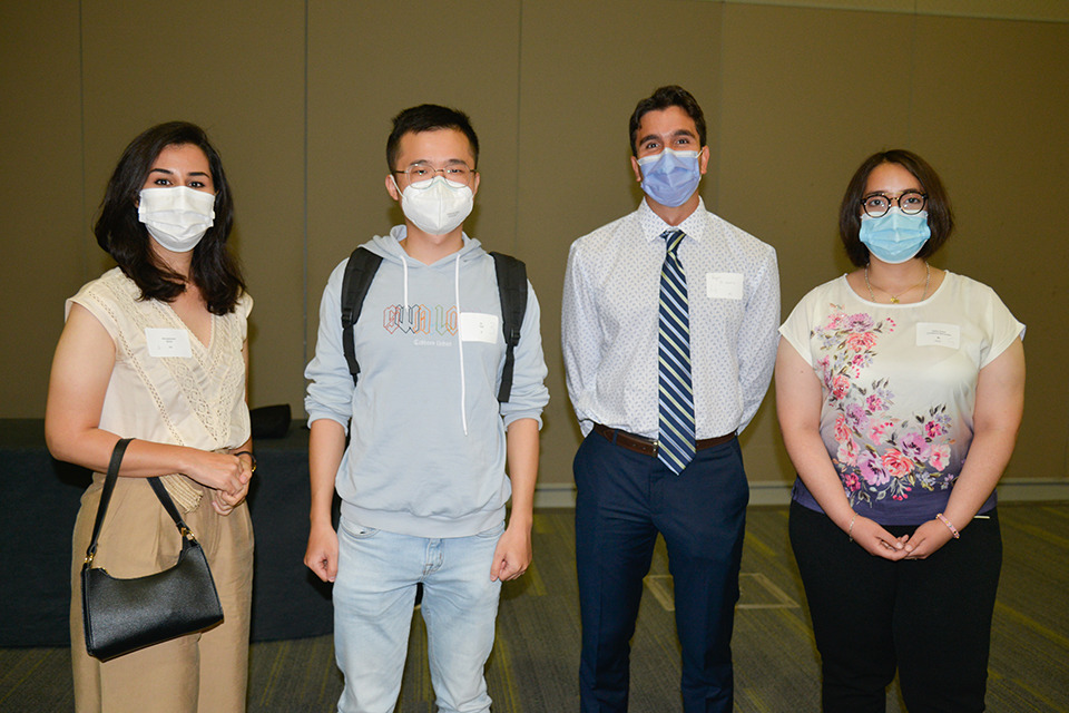 Four medical learners pose wearing face masks.