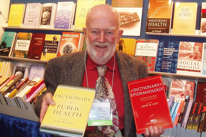Dr. John Last poses with his dictionaries.