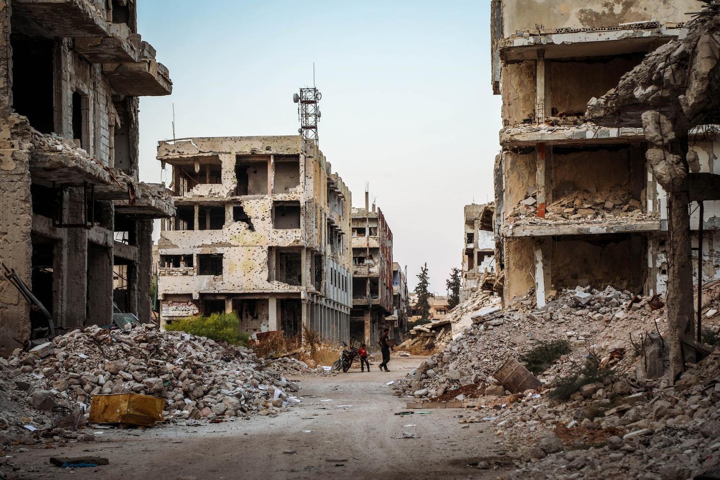 Father and child amid the ruins of Damascus