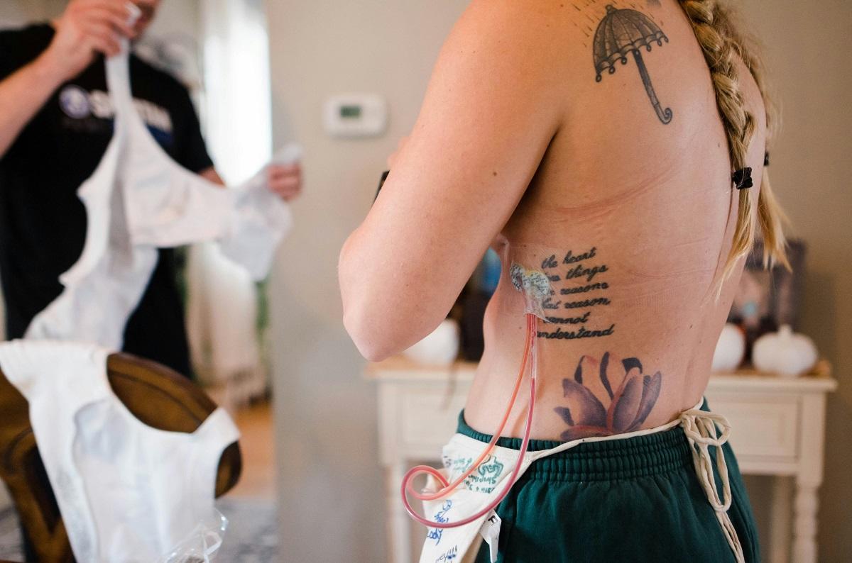 Tattooed woman trying on bra