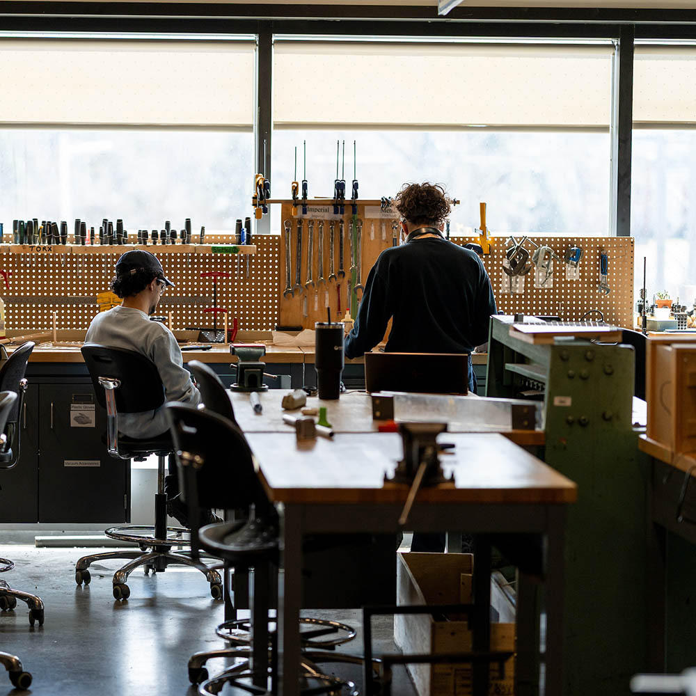 Engineering students working at a bench in the Makerlab