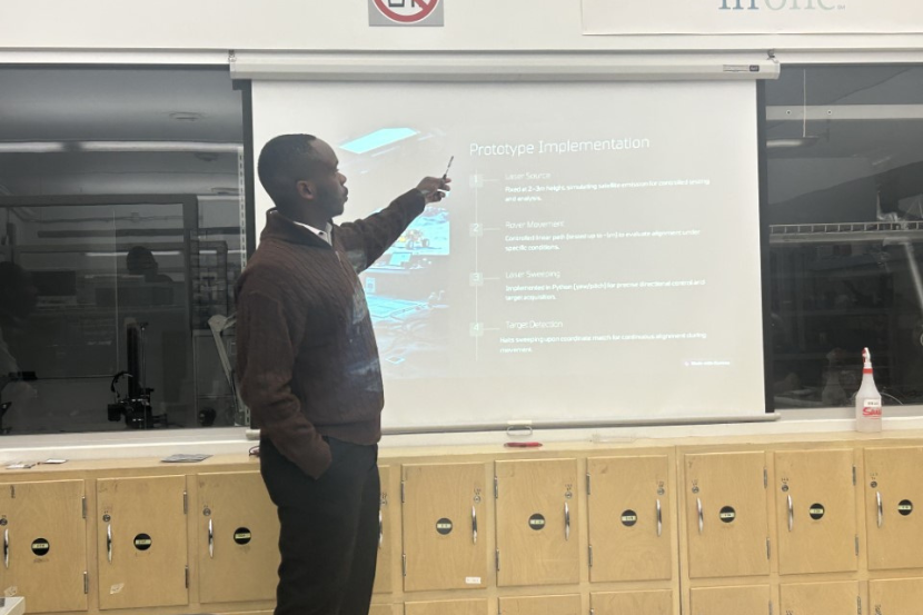 Elam Olame Mugabo delivering a presentation.