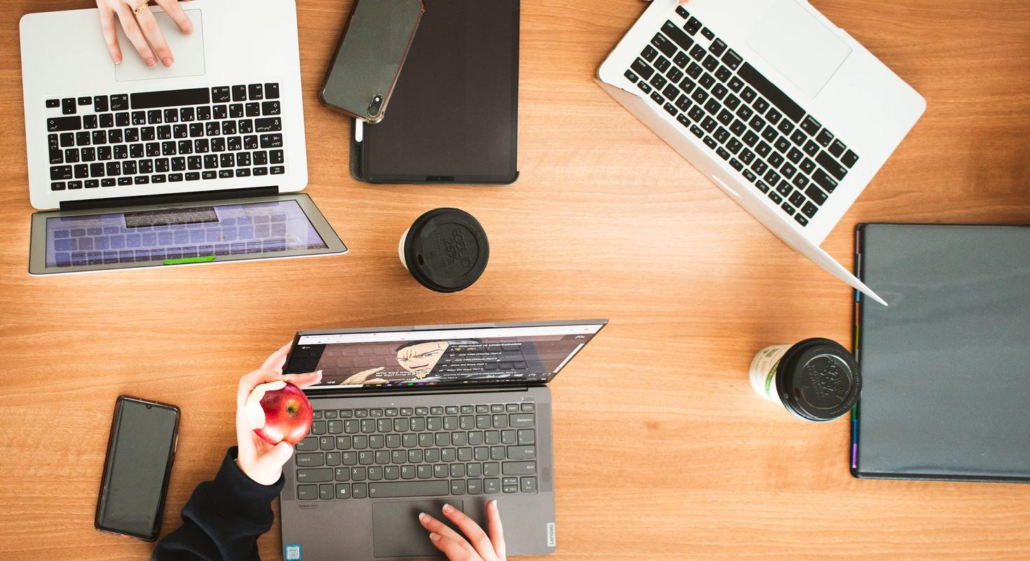 Vue aérienne d'ordinateurs portables, de téléphones et de tablettes sur une table.