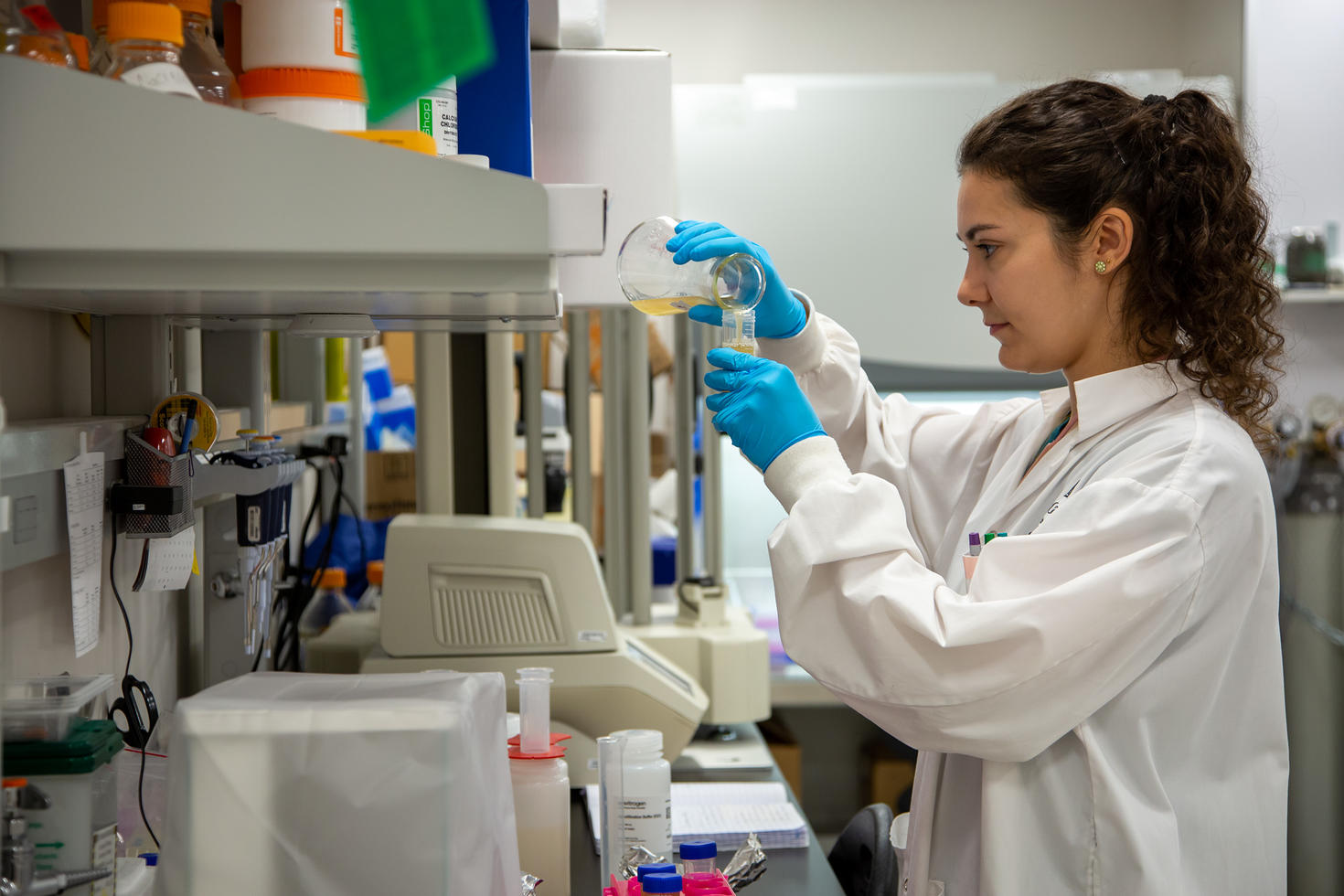 A researcher working with fluids.