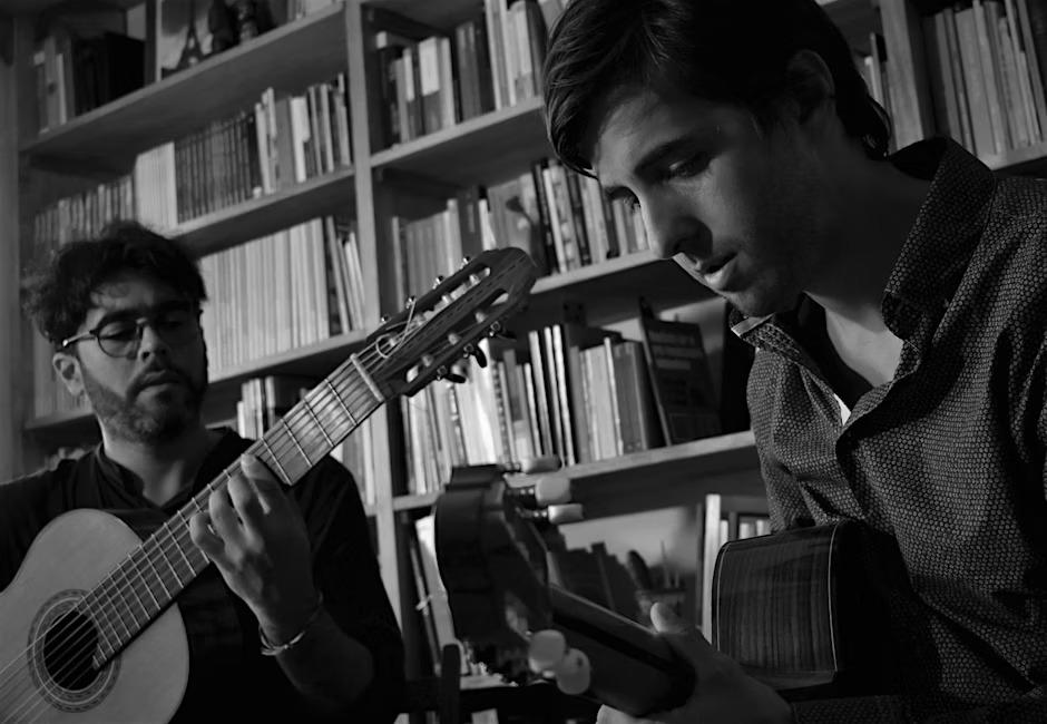 Two people playing guitar
