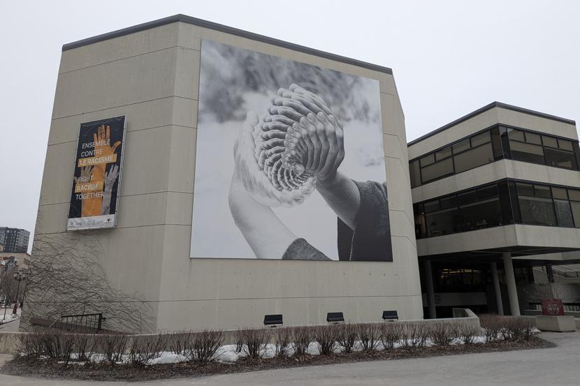 A mural that depicts multi-dimensional, repetitive hands.