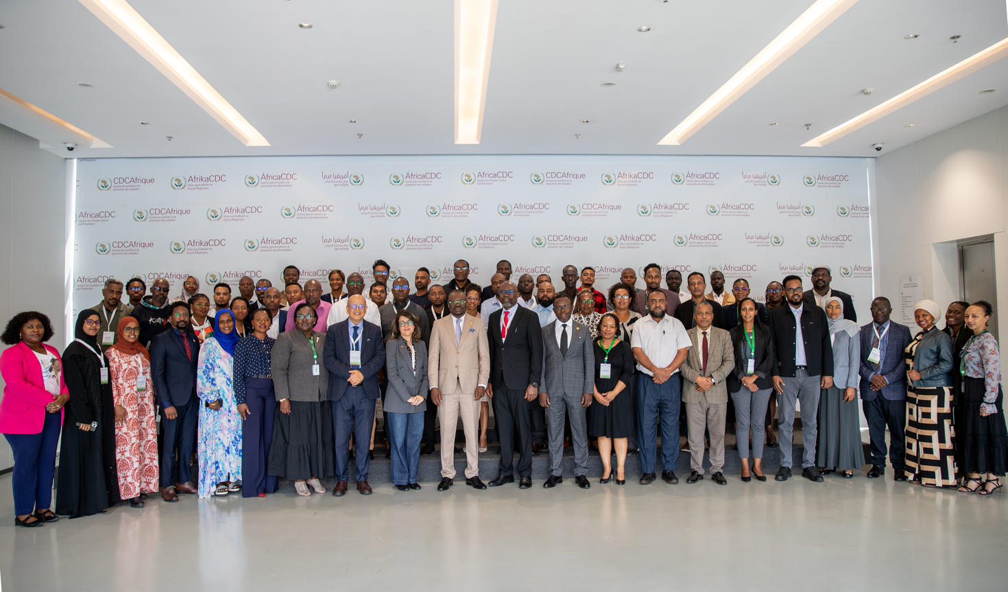 Workshop participants posed in front of backdrop