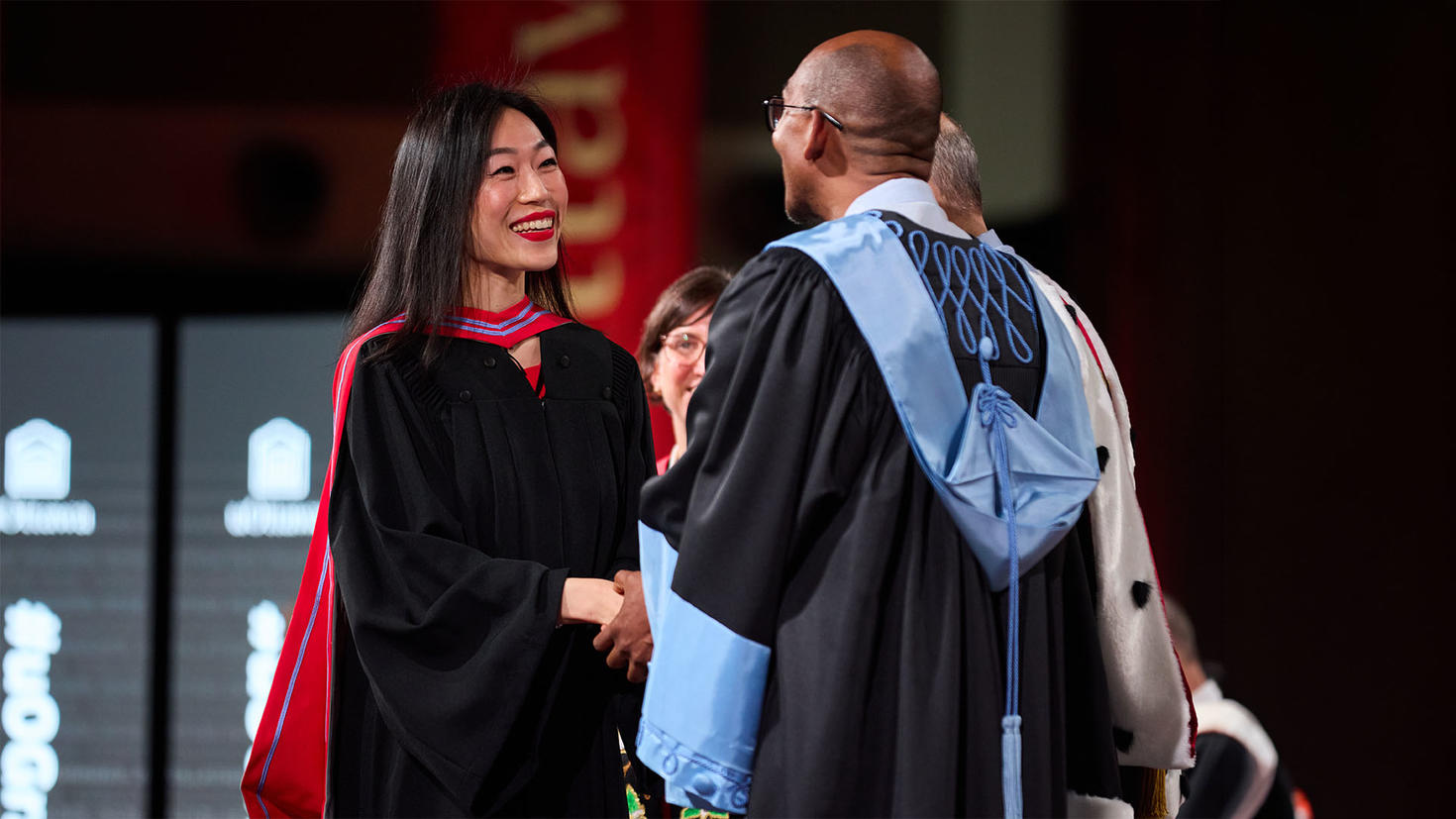 New graduate shaking hands with Faculty Dean