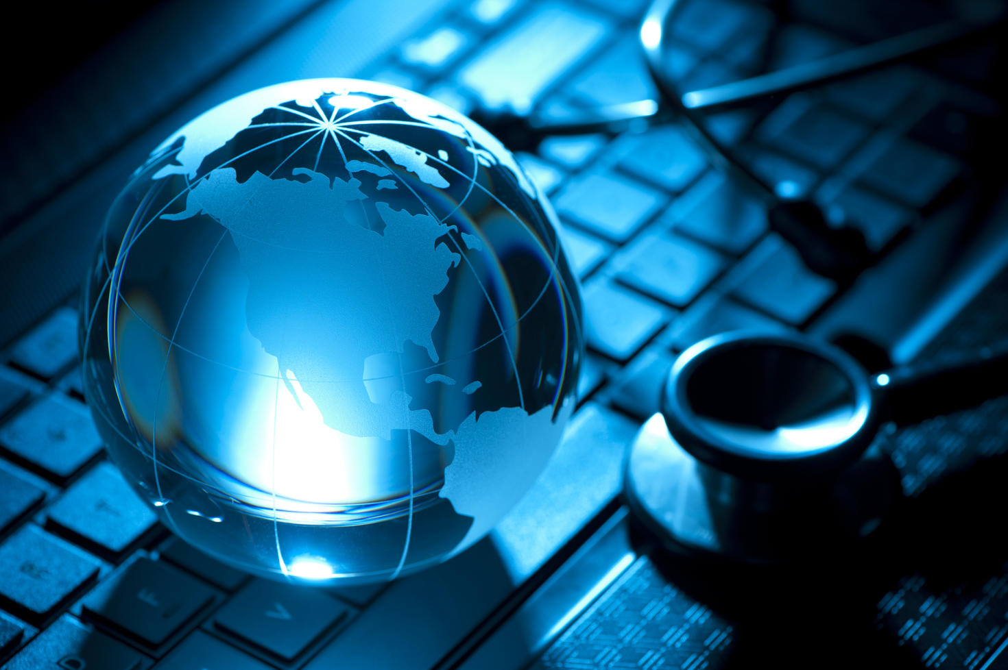 Backlit Stethoscope and globe on a keyboard