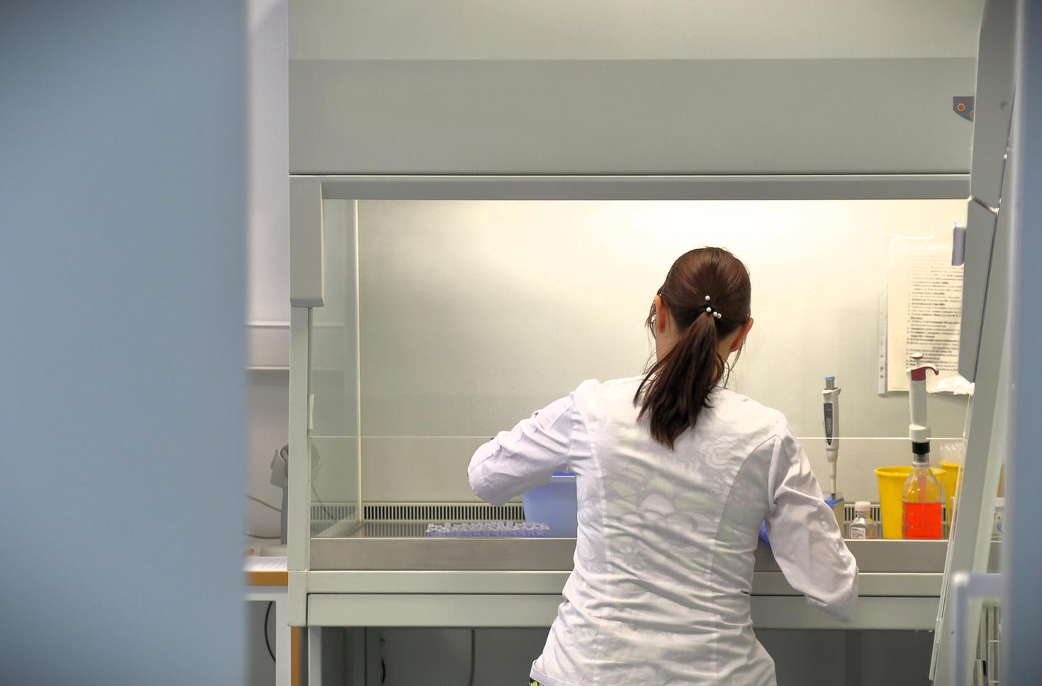 Indigenous female student doing an experiment in a lab. 