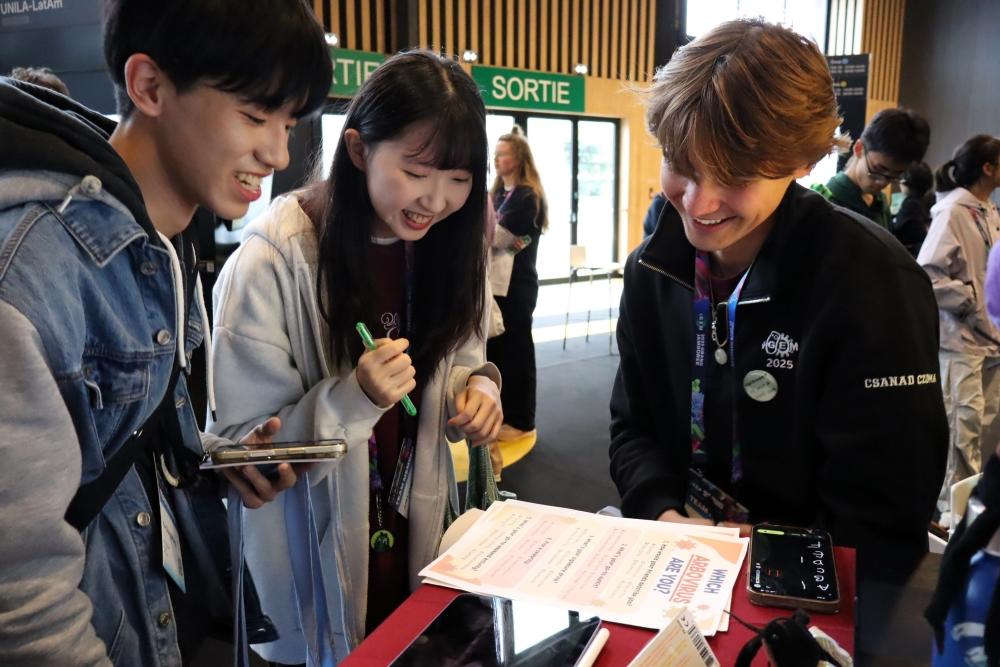 iGEM team member explaining their research to participants. 
