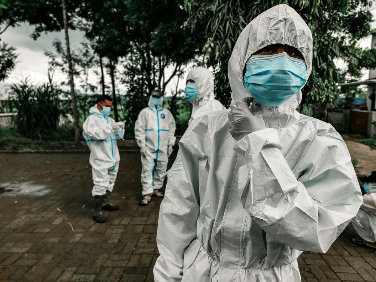 PPE-clad people in the field