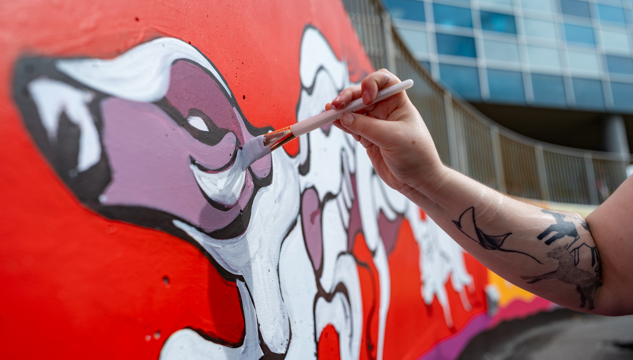 The mural under construction at the O-Train campus gateway.
