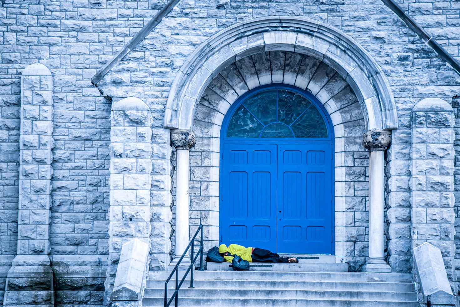 homeless man sleeping on steps 