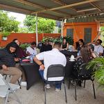 A group of people discussing around a table