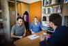 Students talking with counsellor in office.
