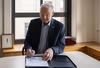 Le président Jacques Fremont signe la charte de Scarborough à son bureau.