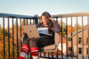 Student reading an article on her laptop