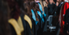 Students from the back wearing academic hoods of different colours