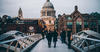 People walking on a bridge in London.