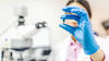 Scientist inspecting a pill.