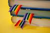 Stack of books with rainbow ribbon