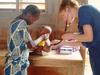 A medical student examines a baby with a stethoscope.