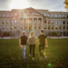 Students walking across Tabaret lawn.