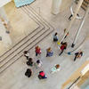 Overhead view of students walking through campus building.