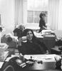 Black & white photograph of three women workers at the National Action Committee on the Status of Women office