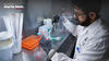 Man in a lab with samples and text Better healthcare starts here