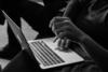 hands on a laptop