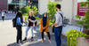 Group of four students having a conversation outdoors on campus