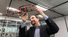 Professor Burak Kantarci holding up a drone