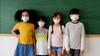 Kids in front of a black board