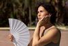 Woman waving a fan