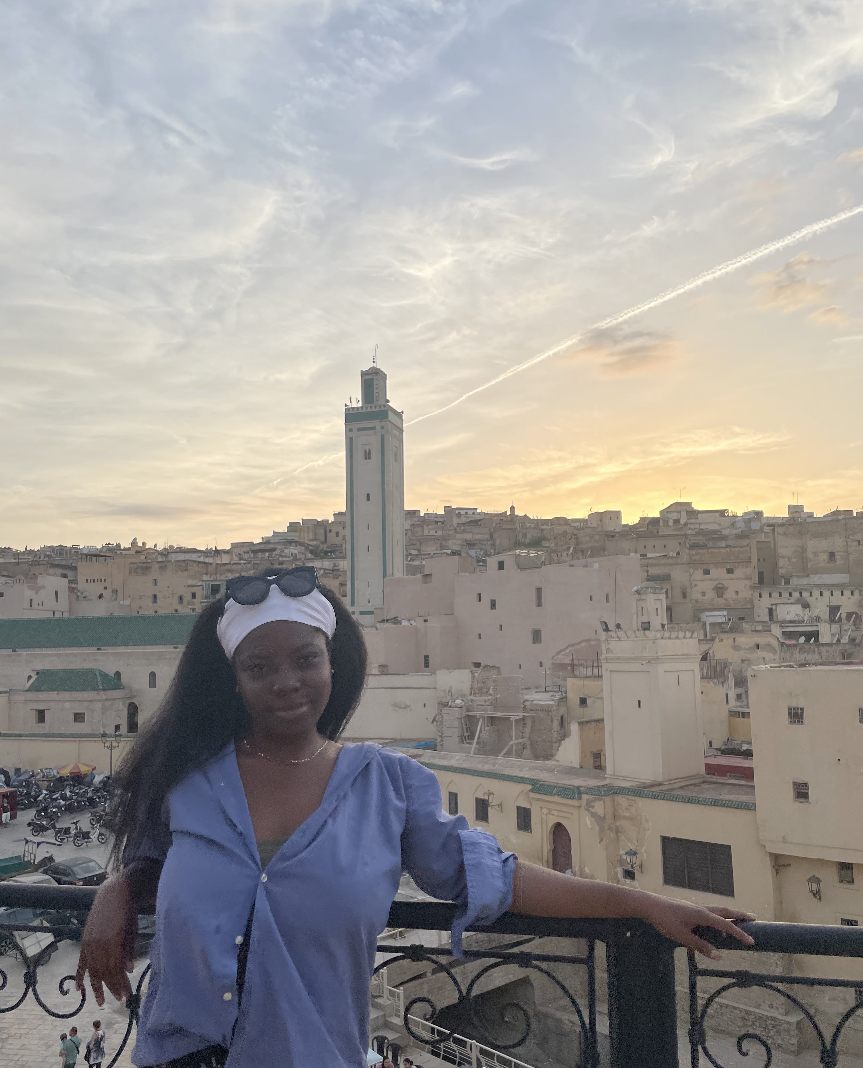 Girl standing in front of old Moroccan buildings